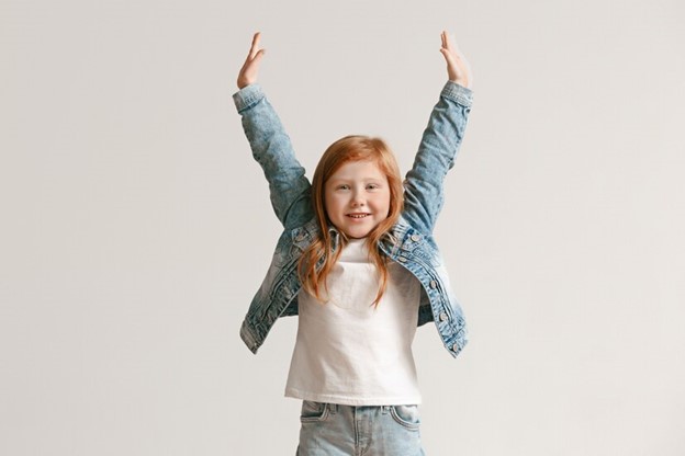 image of a girl holding arms in the air in a power pose.